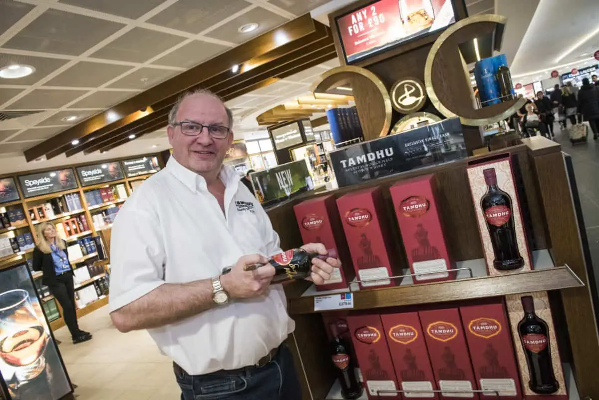 Sandy McIntyre Tamdhu Distillery Manager signing bottles at Edinburgh Airport